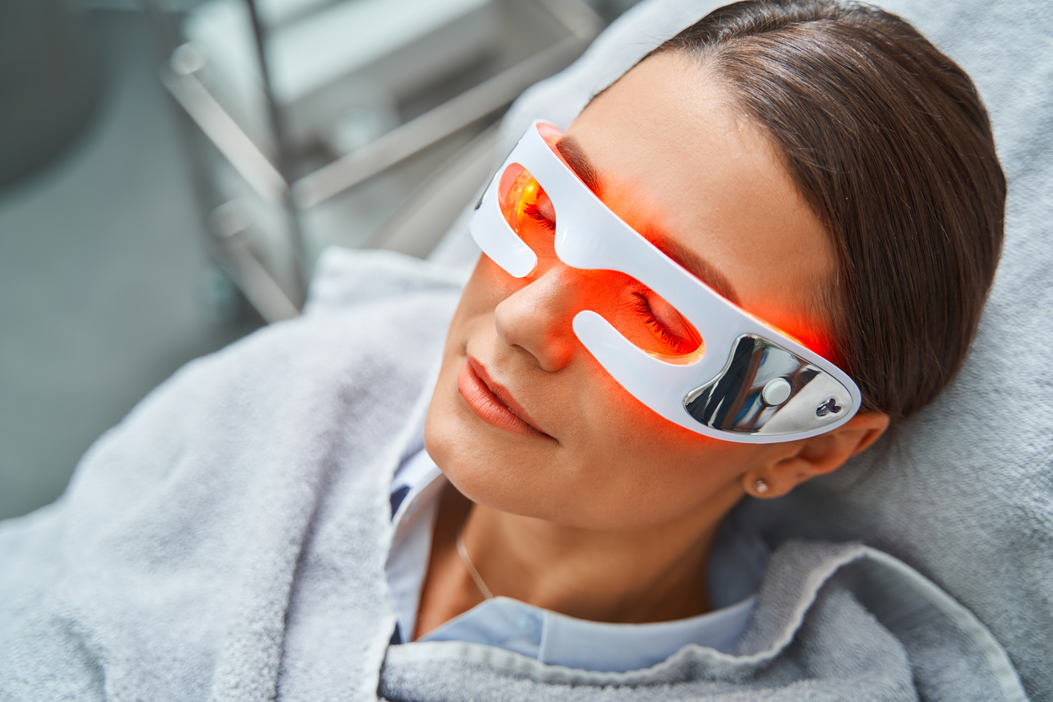 Caucasian female patient in light therapy glasse